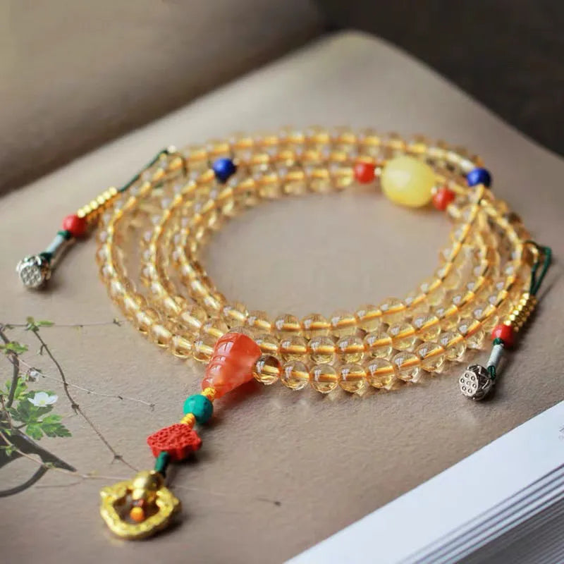 Yellow natural Brazilian citrine bracelet with 1mm beads and filament fastening on a wrist.