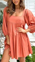 Orange backless children's dress with square collar, puff sleeves, and an A-line skirt.