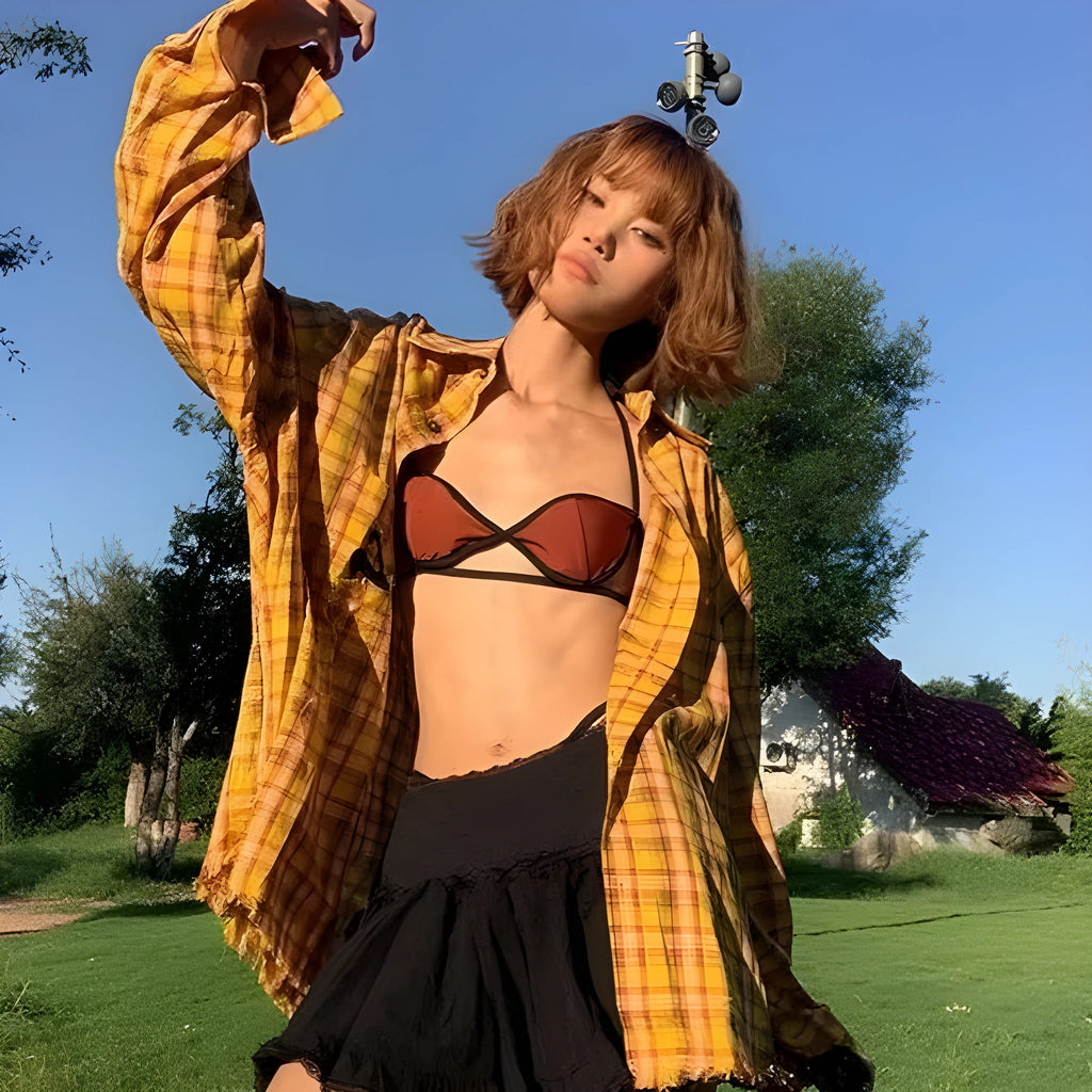 Dopamine yellow and black plaid shirt on a hanger, showing loose fit and cardigan style.