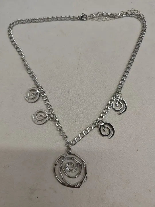 Spiral donut jewellery set showing necklace, bracelet, and ear hooks in gold or silver tone alloy