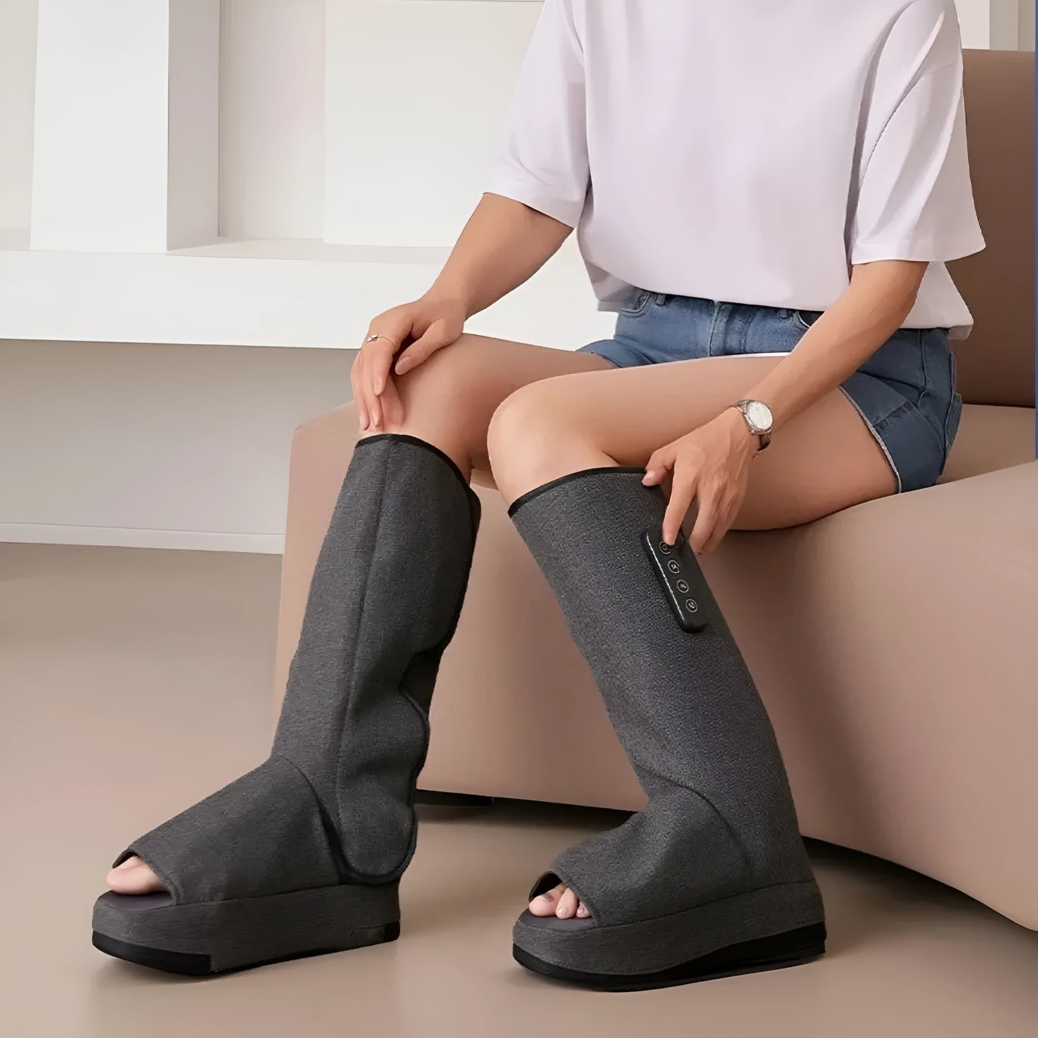 Dark grey leg massaging machine with air wave compression and USB charging cable