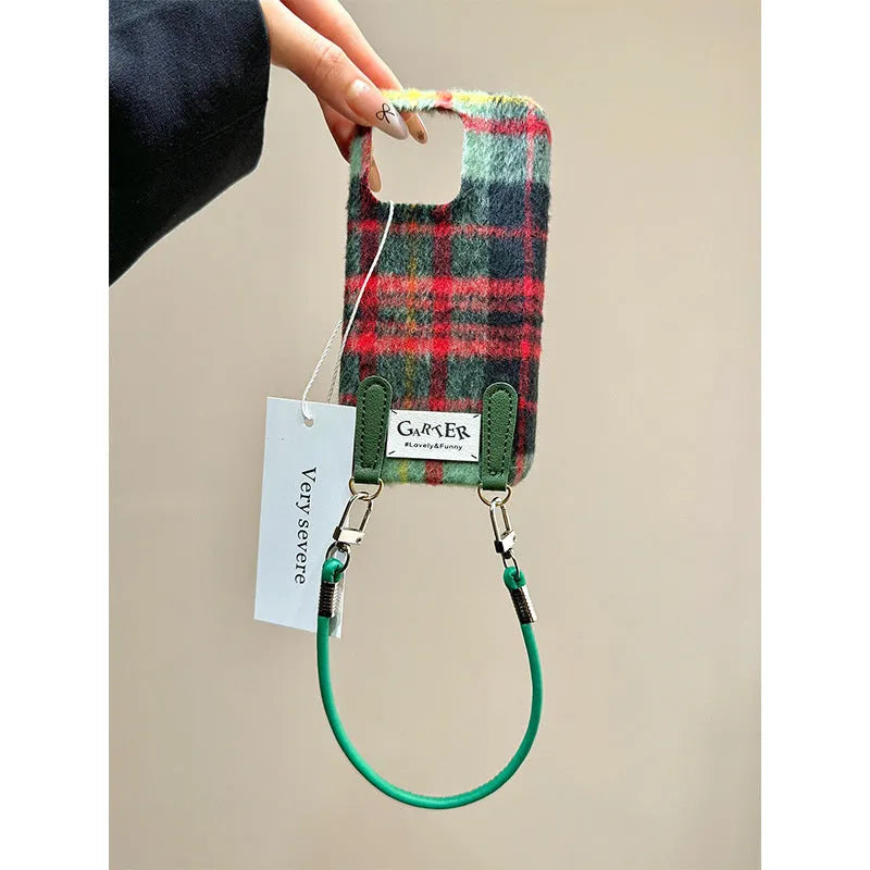 Flannel plaid phone case with wristband in black green and red checkered, compatible with iPhone models.