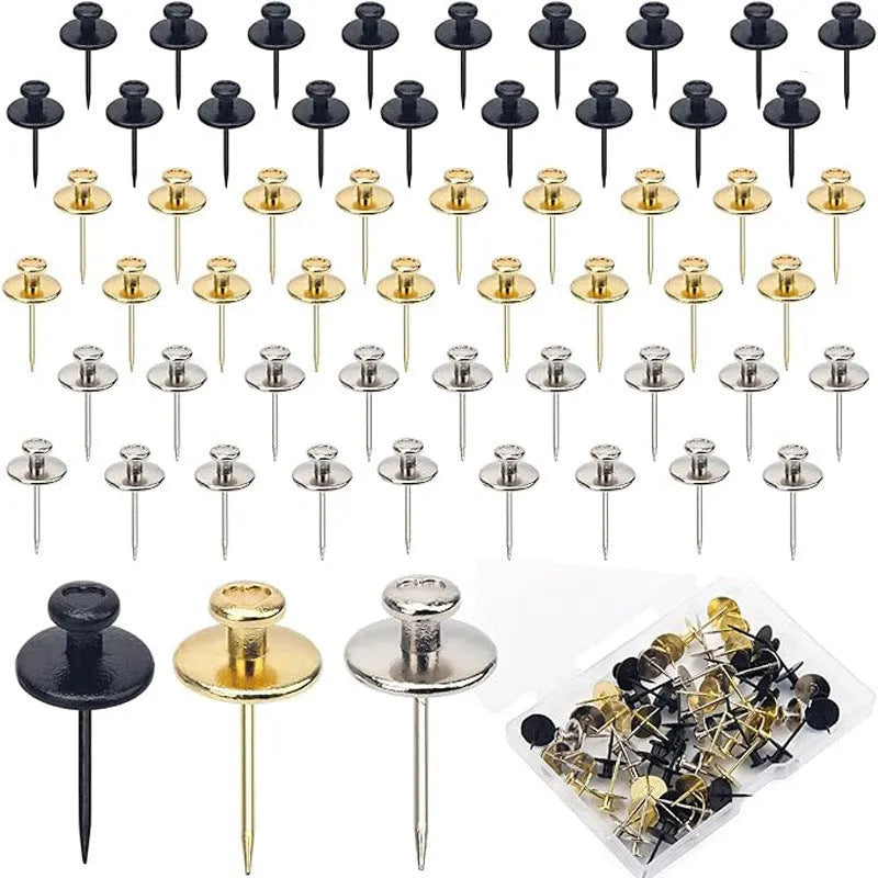 Fancy thumb tack set in mixed colours black gold silver bronze on a corkboard surface