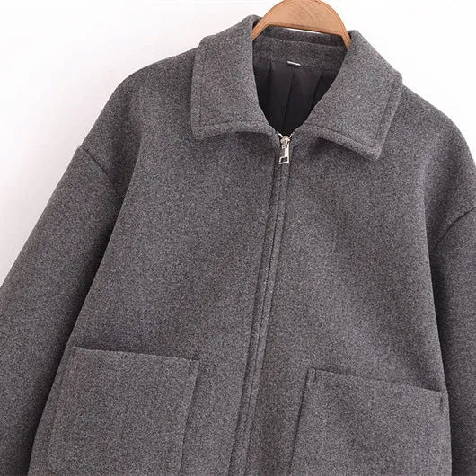 Women's gray PU jacket with shirt-collar, zip front, and long sleeves on a model
