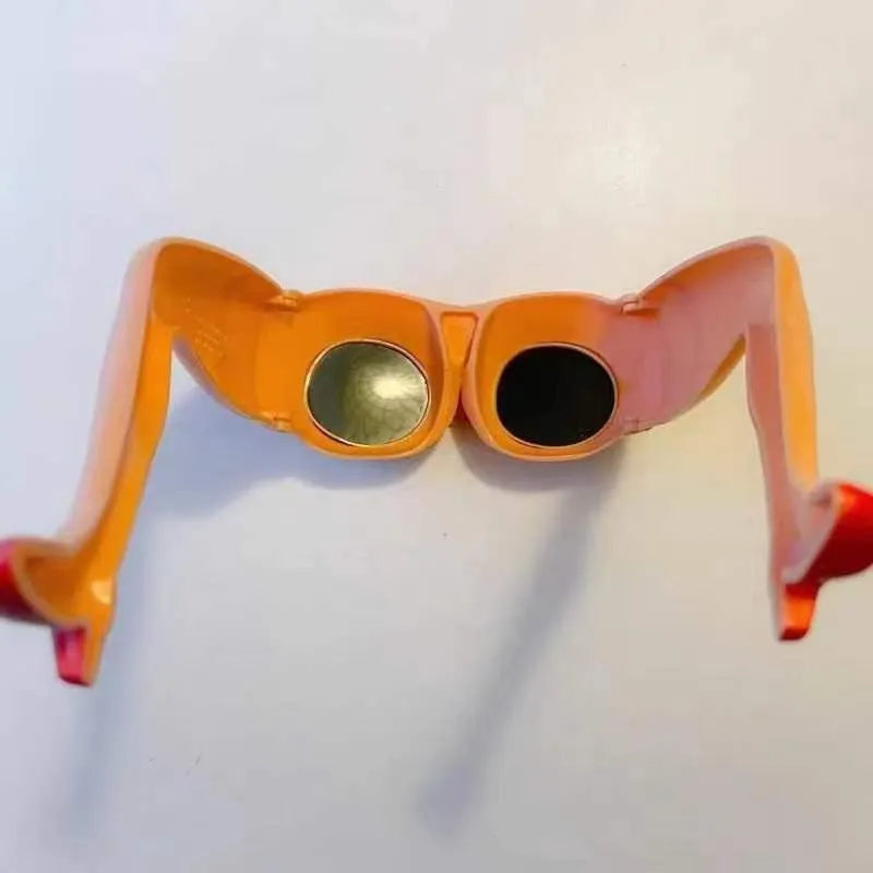 Orange plastic novelty sunglasses designed in the shape of a hip and leg.