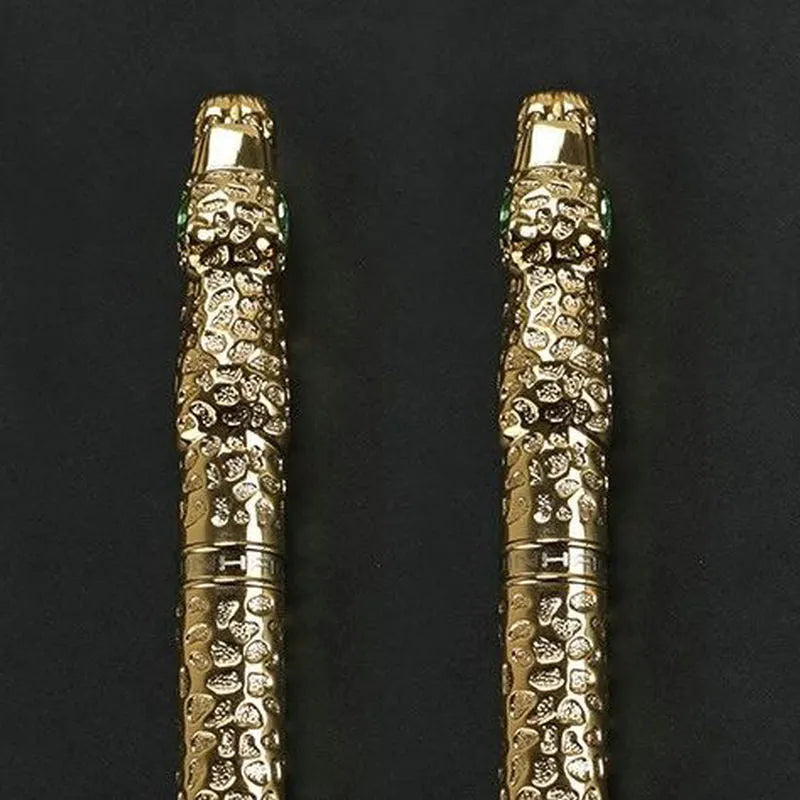 Embossed metal business pen in ancient silver or gold colour on a plain background.