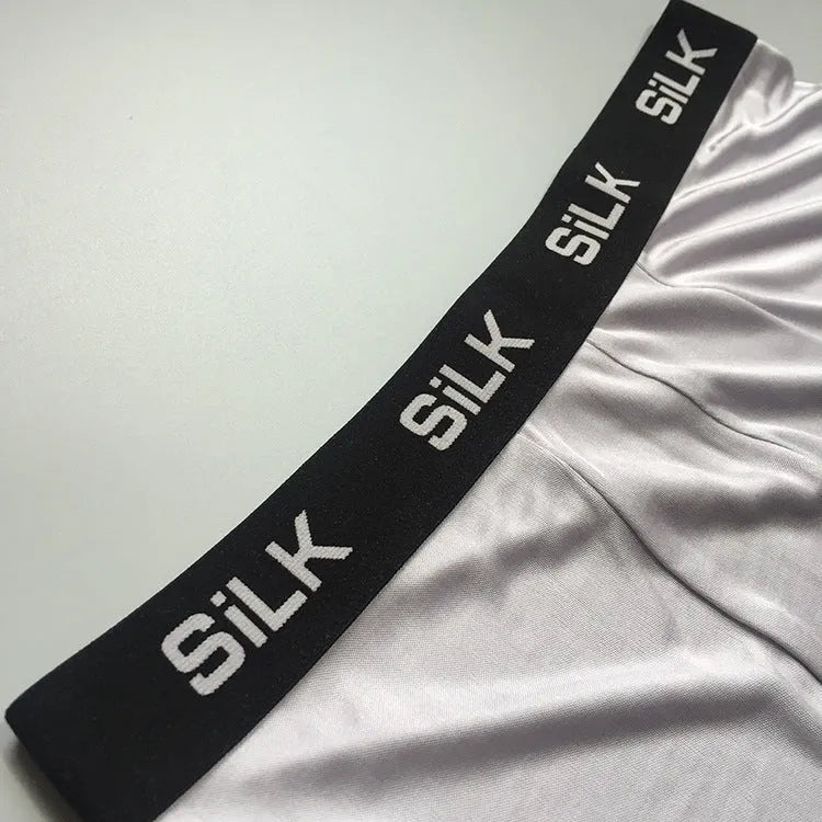 Men's loose fit silk shorts in navy blue, skin colour, and silver grey options with mid-waist design