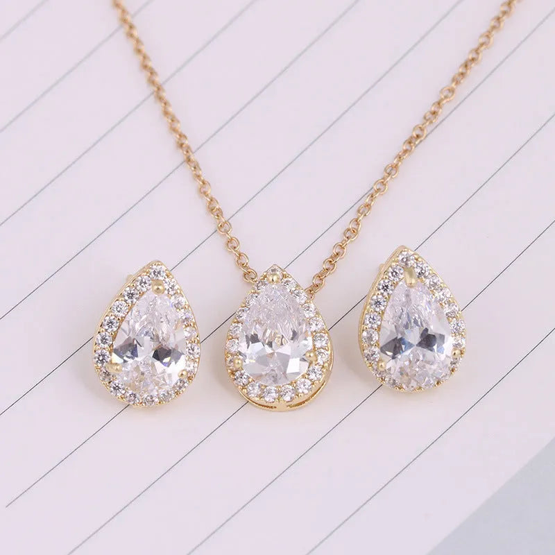 Women's water drop gemstone necklace and earrings set in copper with zircon on white background