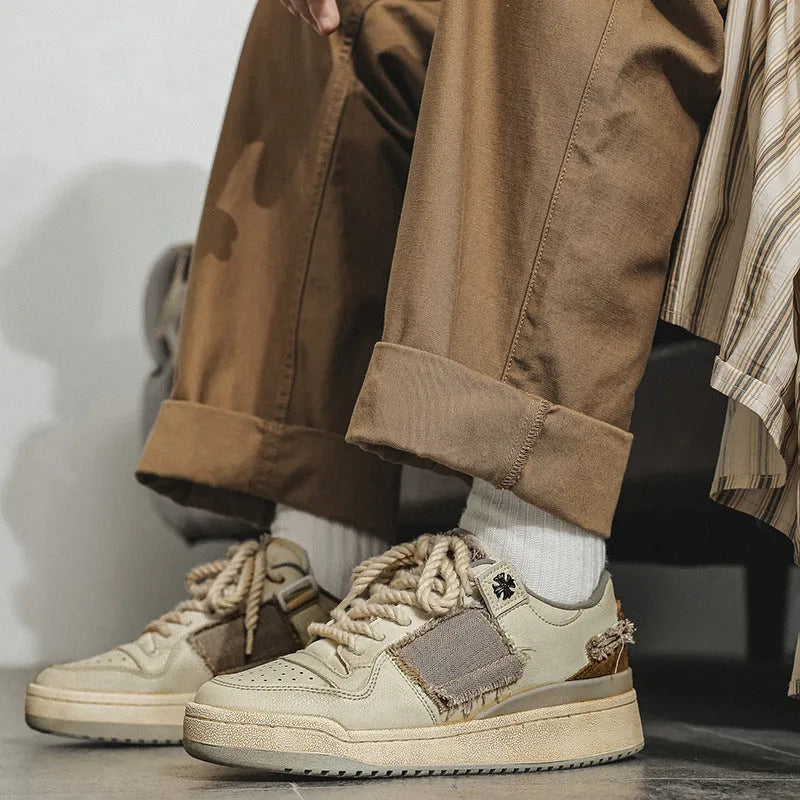 Beige low-top skateboard shoes with vintage patch design and rubber sole