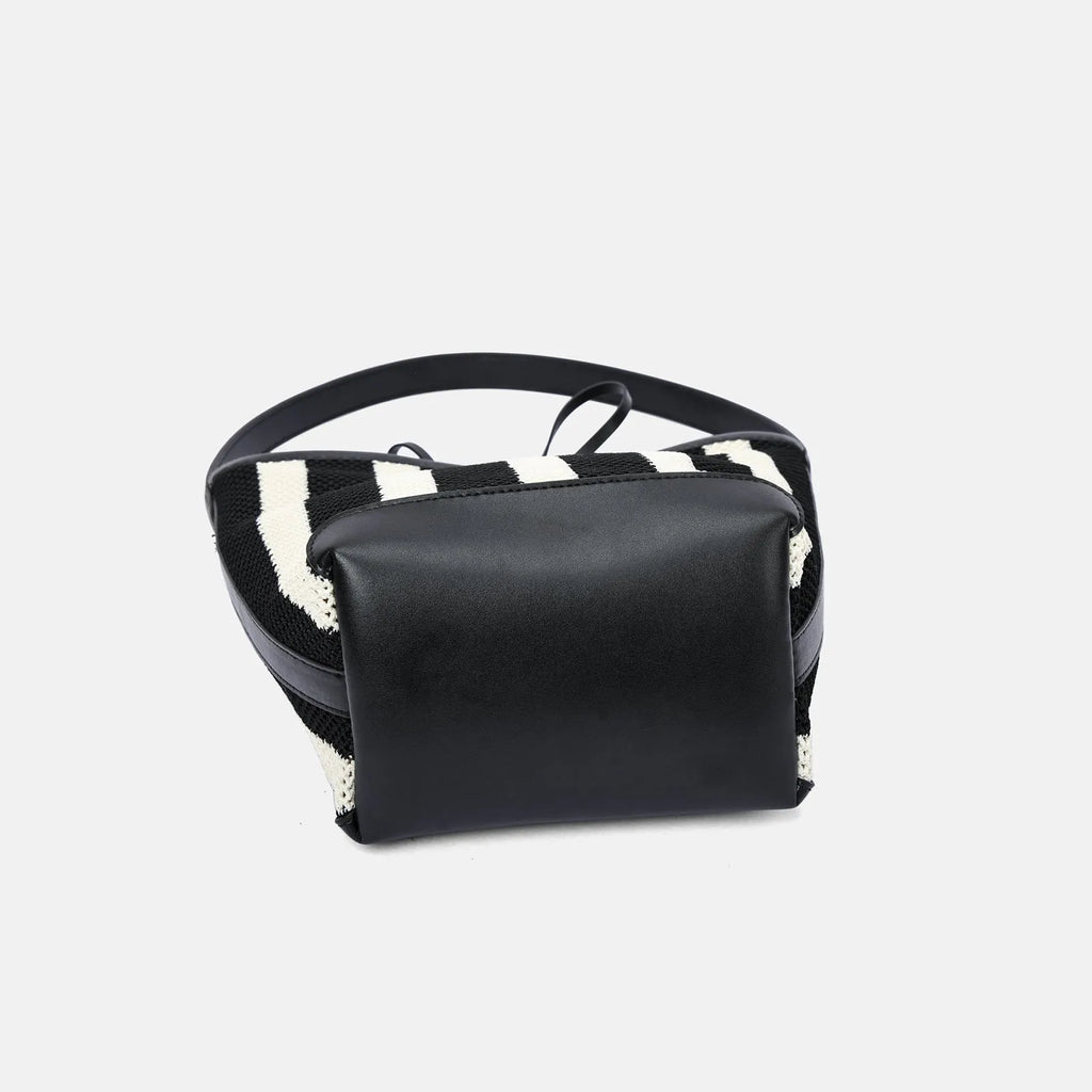 Black and white striped woven fabric women's bucket shoulder bag.