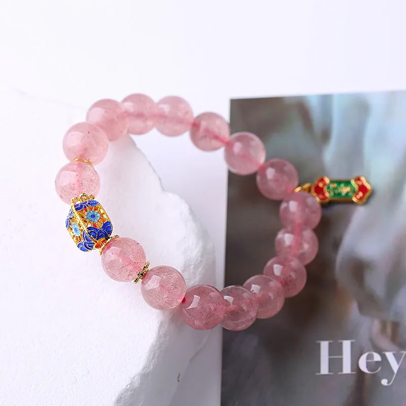 Pink strawberry quartz crystal bracelet with Ruyi charm and hand-woven design for women.