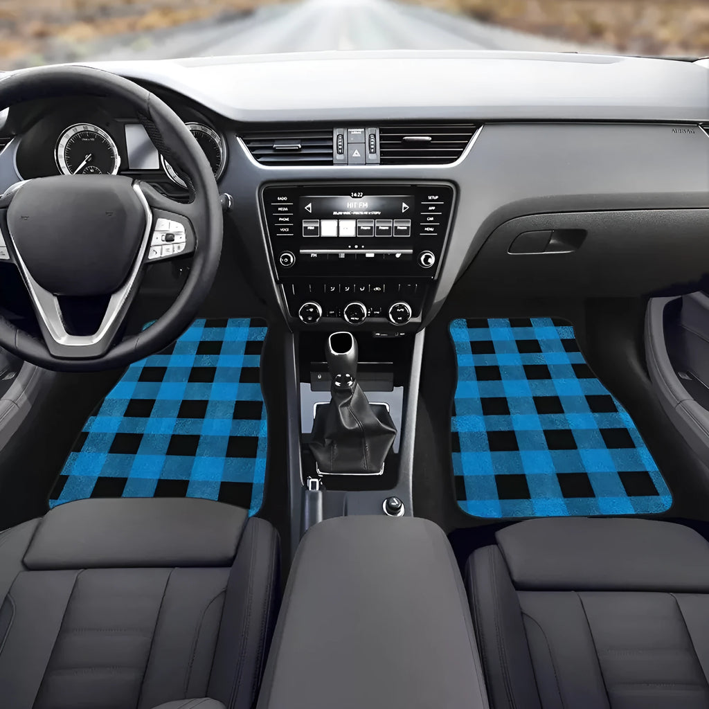 Black four-piece rubber car foot mat set with textured surface, shown on a car floor.