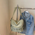 A square-shaped nylon crossbody bag for women in a choice of colours, showing shoulder straps and external pocket.