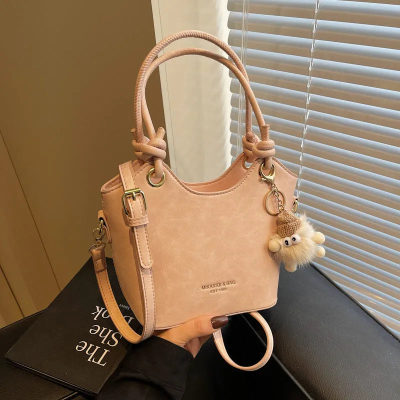 Small square PU crossbody bag in solid colour with zipper closure and single shoulder strap