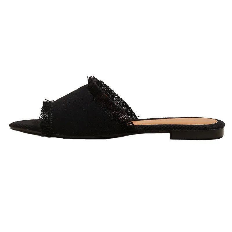 Women's flat denim slippers with a tassel detail in apricot colour on a white background