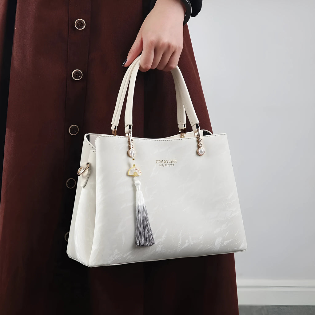 Women's square shoulder bag in PU leather with ethnic detailing and slit pocket