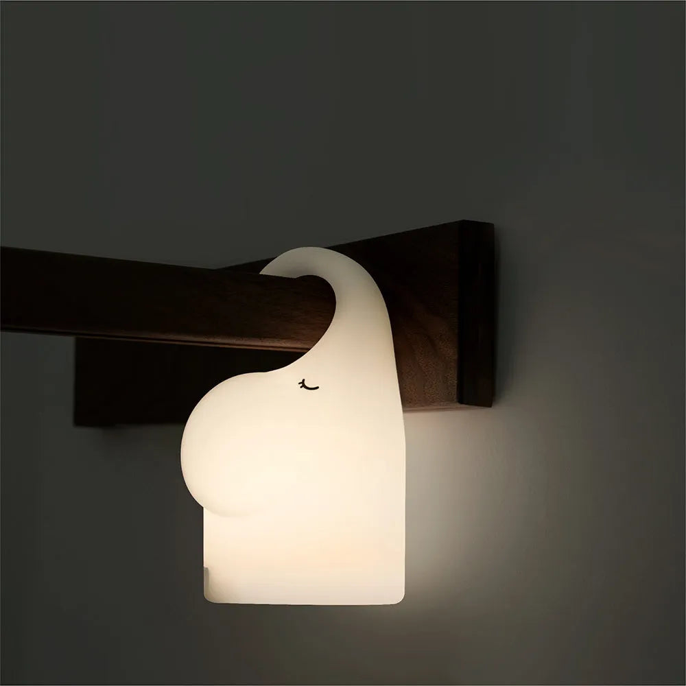 DOMI Elephant shaped night light with soft silicone body and warm white LED glow.