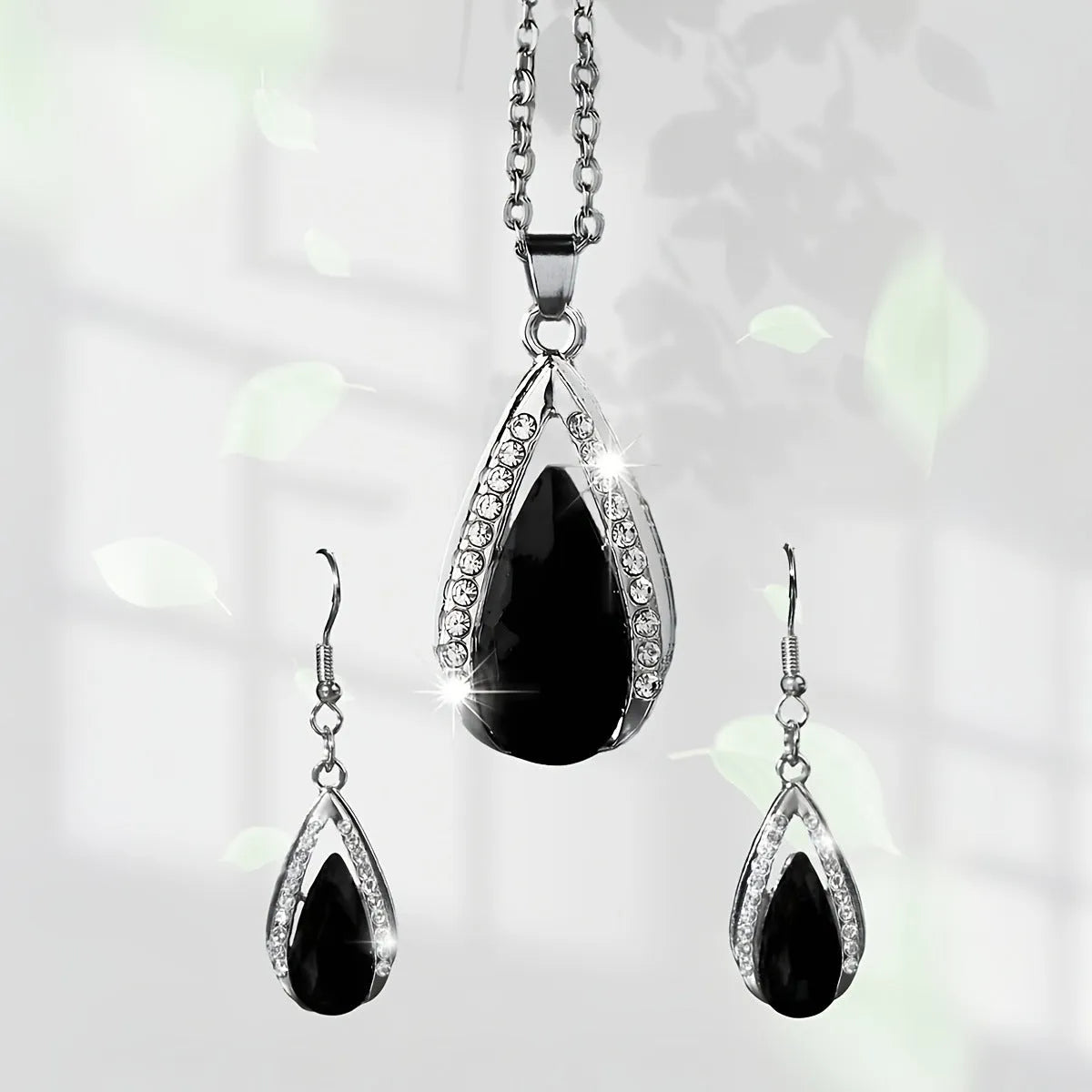 Teardrop pendant necklace and matching earrings jewellery suite in alloy with black or red glass accents