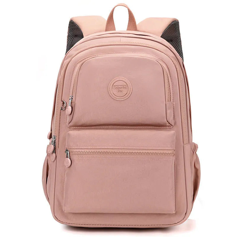 Women's nylon travel backpack in Azure Stone Green showing multiple compartments and organisational features