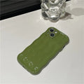 Solid-colour silicone iPhone case with a water ripple texture on the back.
