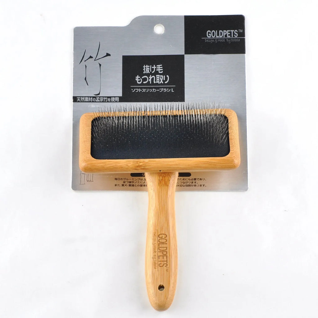 Pet grooming bamboo wood air cushion needle comb in original bamboo colour with steel pins, shown on a table