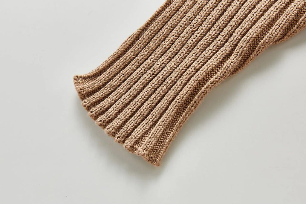 Baby long-sleeved knitted jumpsuit romper pullover in beige, size 80cm, lying flat on a white background