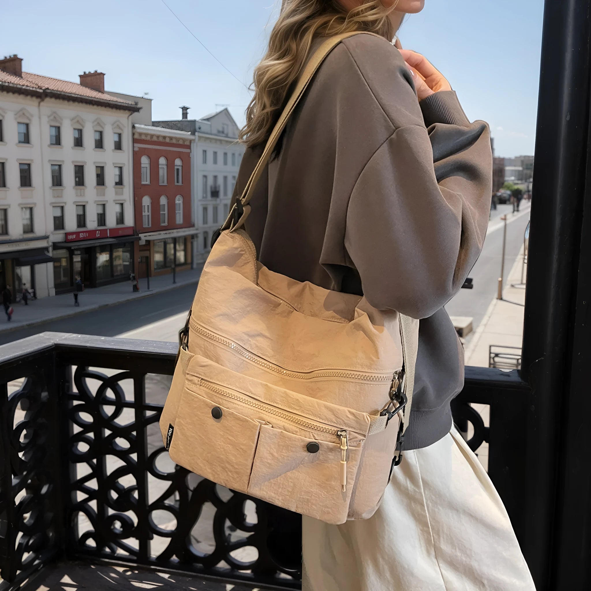 A square-shaped nylon crossbody bag for women in a choice of colours, showing shoulder straps and external pocket.