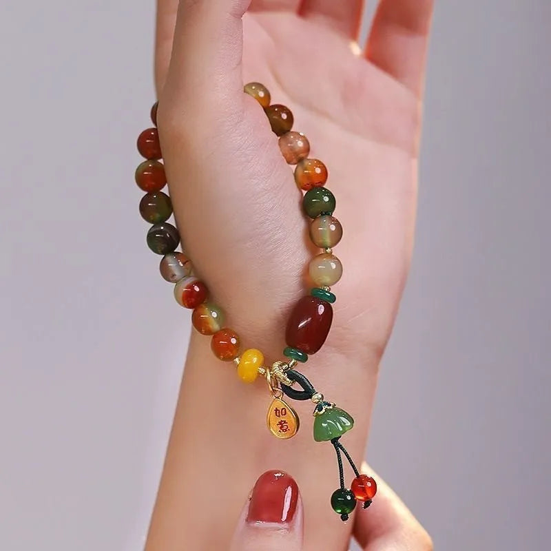 Close-up of a manually crafted lotus motif bracelet made from mixed materials in a national style.