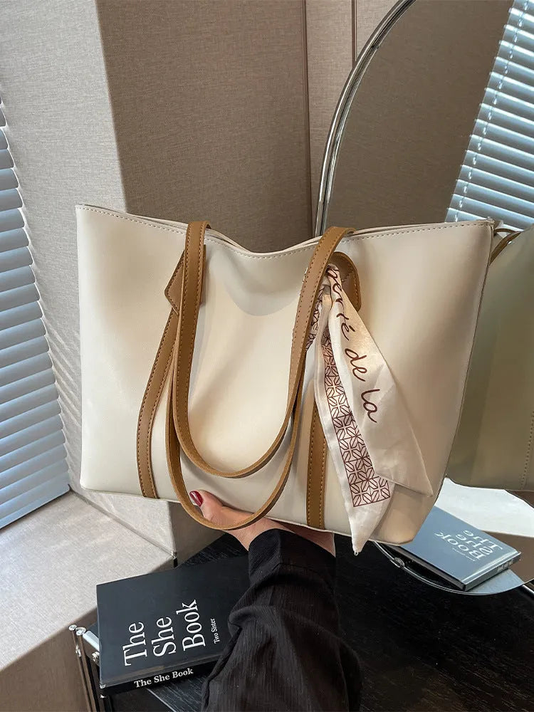 Soft large tote shoulder bag with crossbody strap in multiple colour options including black, khaki, and white with coloured trim