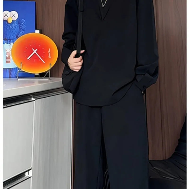 Men's black casual two-piece suit with long sleeve polo shirt and trousers on a hanger