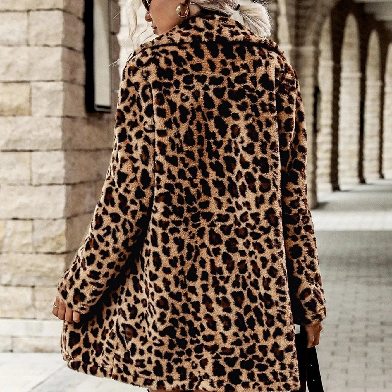 Leopard print long sleeve furry coat top with animal pattern on a plain background
