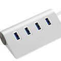 Silver aluminium alloy four-port USB 3.0 hub on a desk with cables connected, 98x58x30mm