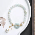 Handcrafted jade pearl bracelet with peace buckle closure in traditional Chinese style