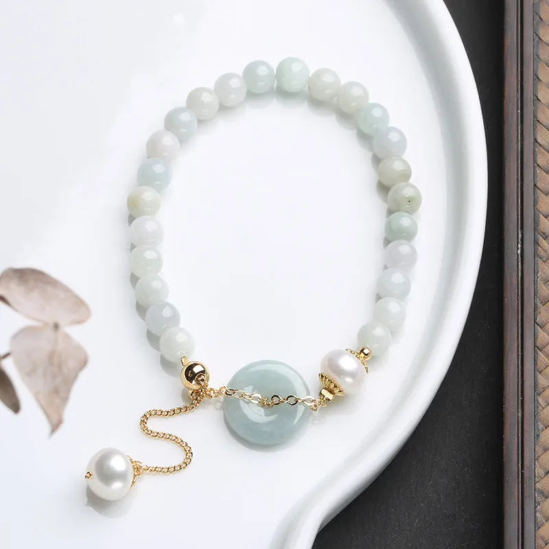 Handcrafted jade pearl bracelet with peace buckle closure in traditional Chinese style