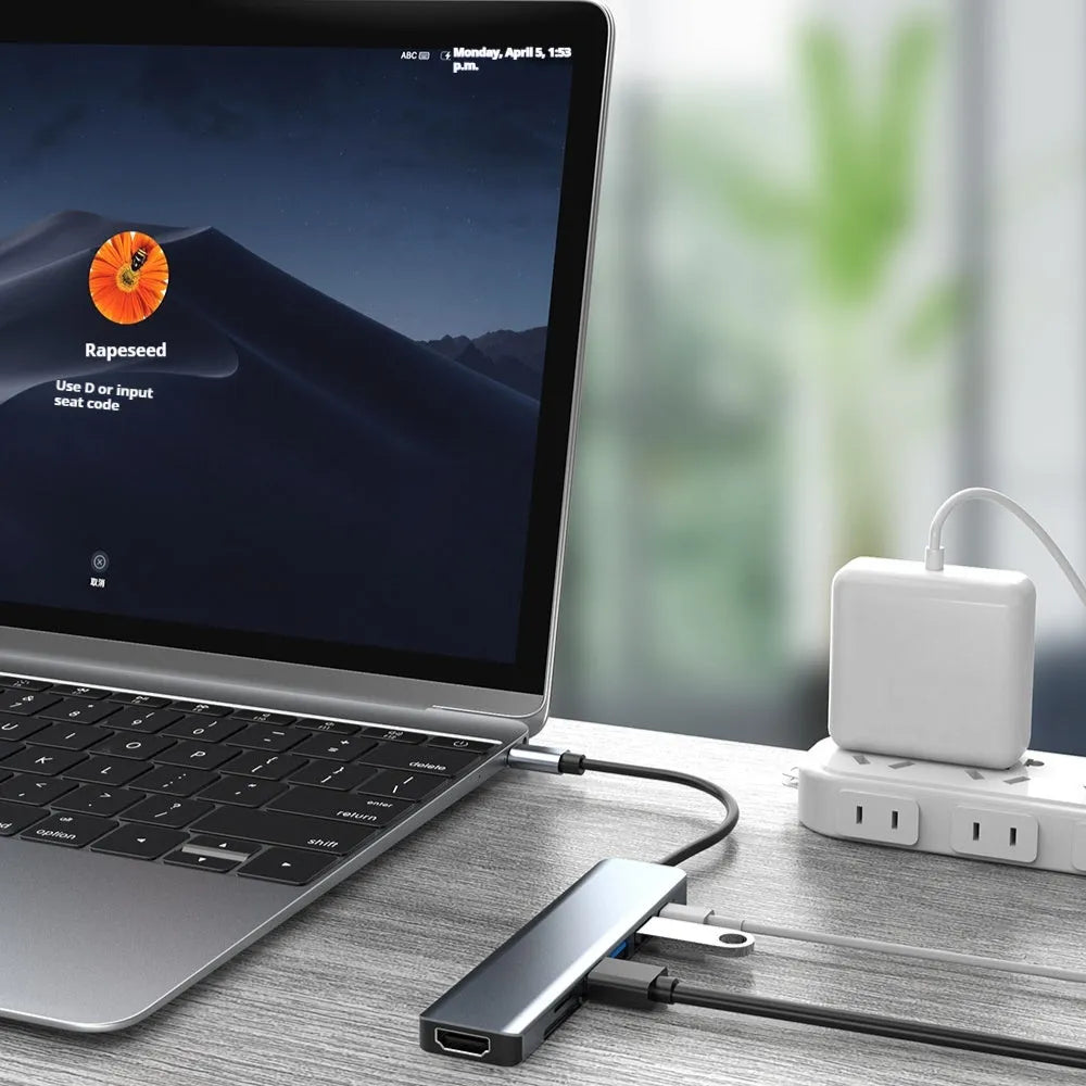 Seven-port USB expander with a short Type-C cable connected to a laptop.