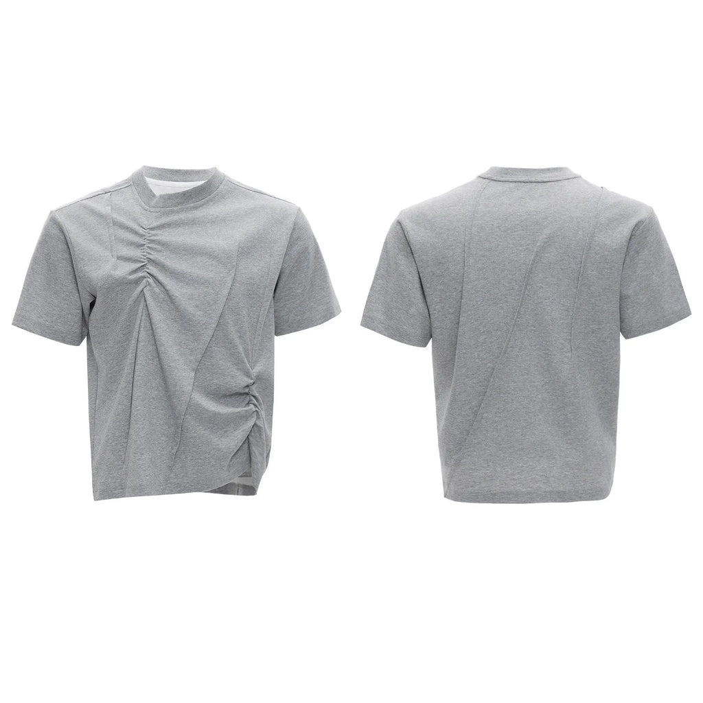 Men's loose black cotton T-shirt with textured pleats and asymmetric design detail.