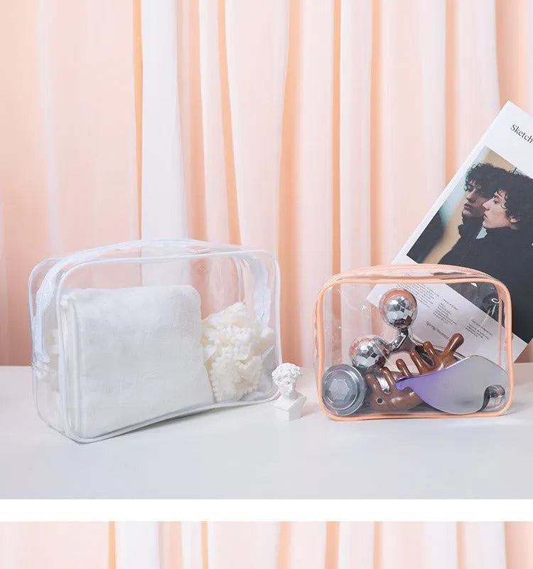 Set of three semi-transparent PVC makeup bags in black, pink, and white colours with handles