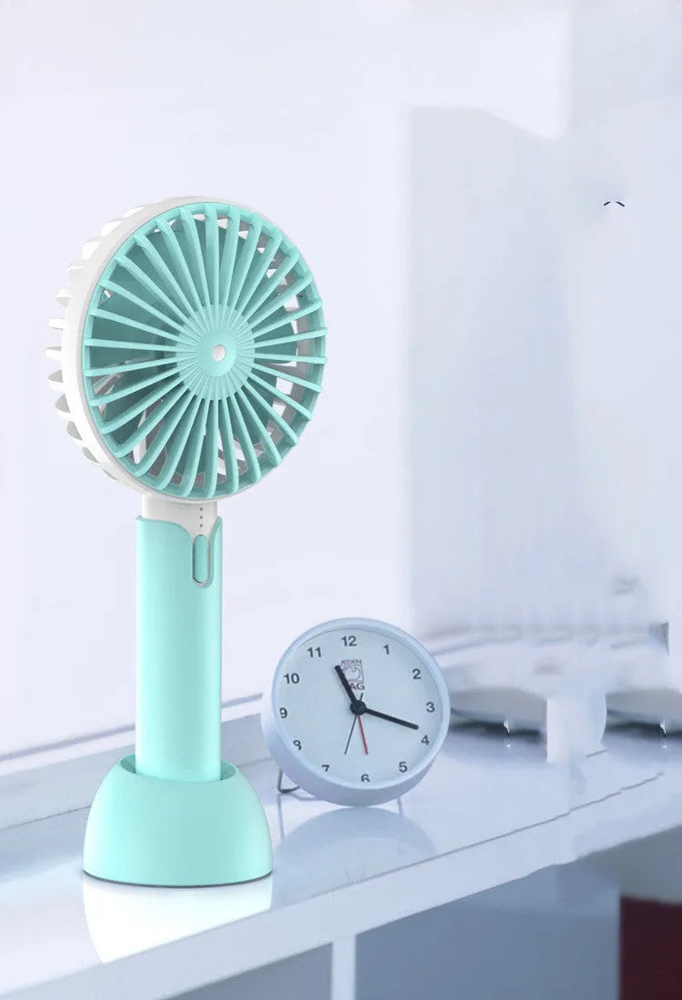 Blue USB-powered mini desk fan with three-speed settings and oscillating head on desktop