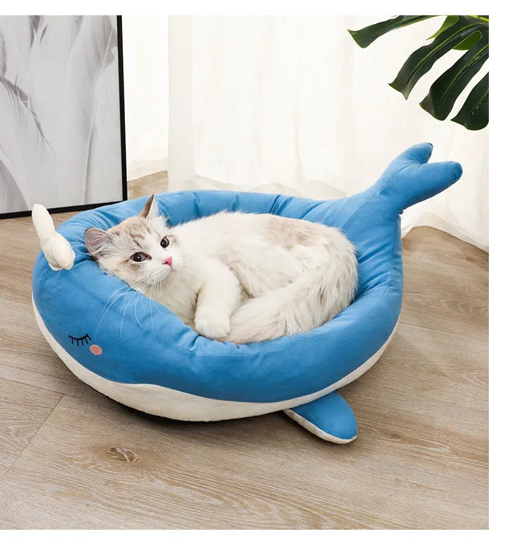 Blue duck-shaped fluffy pet bed for small dogs and cats on a wooden floor.
