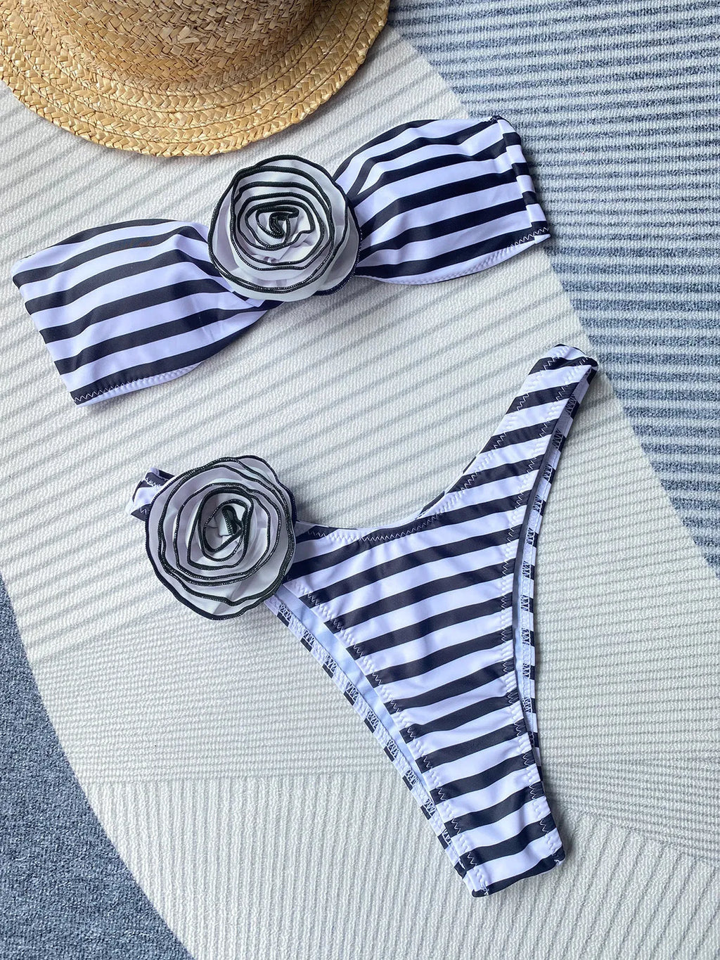 Black and white striped bikini swimsuit with tube top and three-dimensional floral split detail on the shorts.