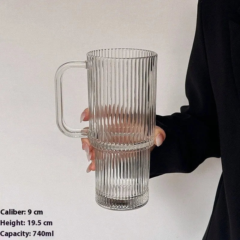 740ml round glass cup with handle, lid, and bent straw on modern table setting