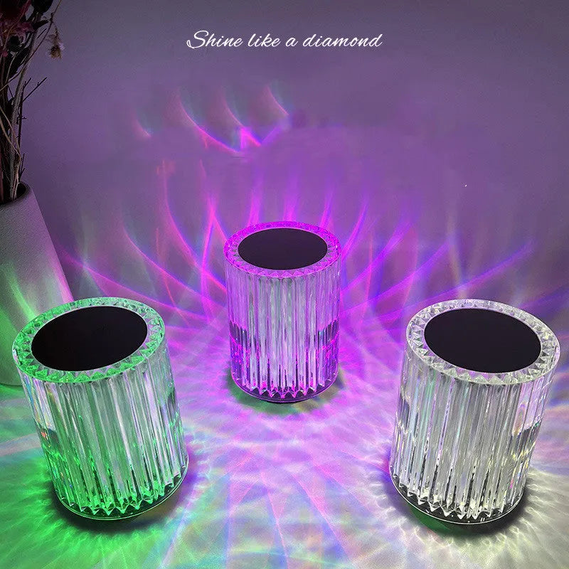 Compact acrylic crystal LED table lamp with RGB colours and remote control on a desk