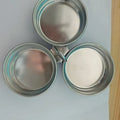 Mini stainless steel egg steamer in heart-shaped and round designs on a kitchen counter.