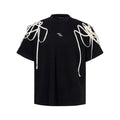 Black loose fit short-sleeved T-shirt with padded shoulders and rivet ribbon trim.