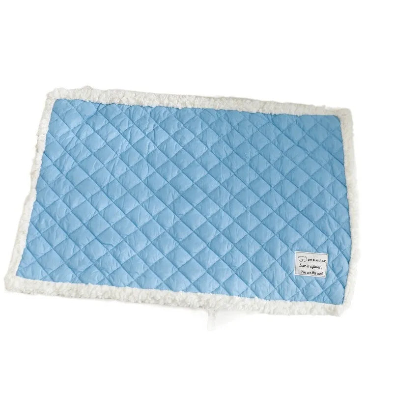 Blue quilted terry cloth pet blanket for cats showing textured surface and size scale.