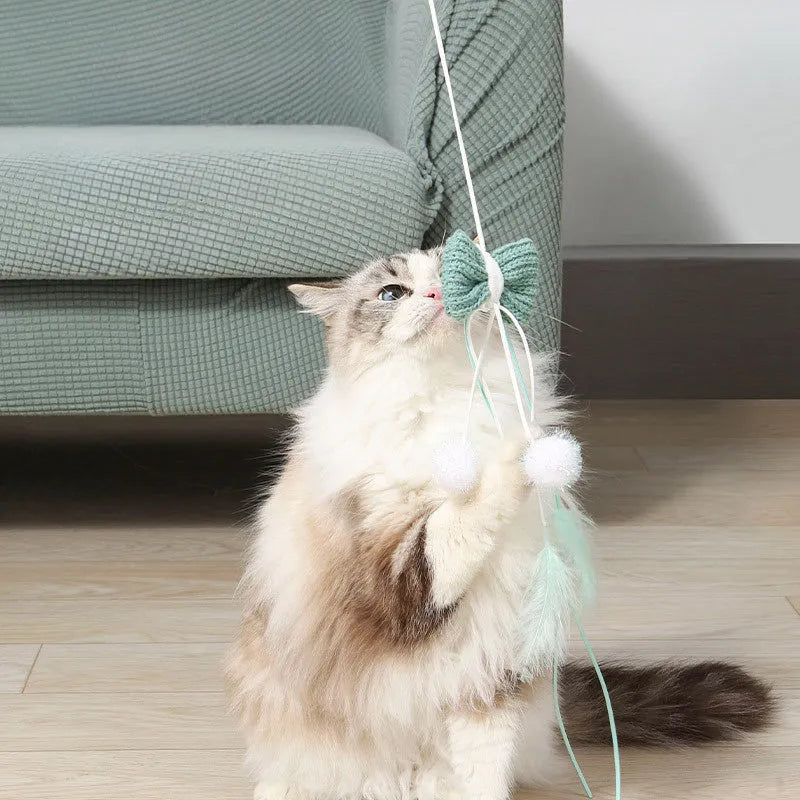 Blue cat teaser toy with a long pole, inflatable ego shape, and colourful feathers.