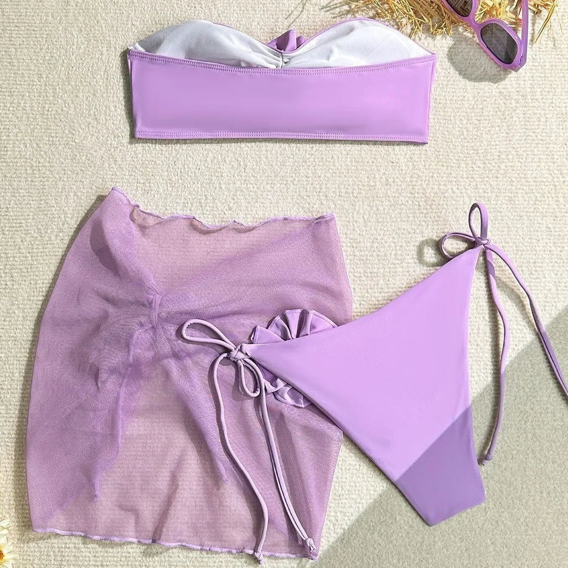 Women's pink tube top swimsuit with large 3D tied flower, matching skirt and pants.