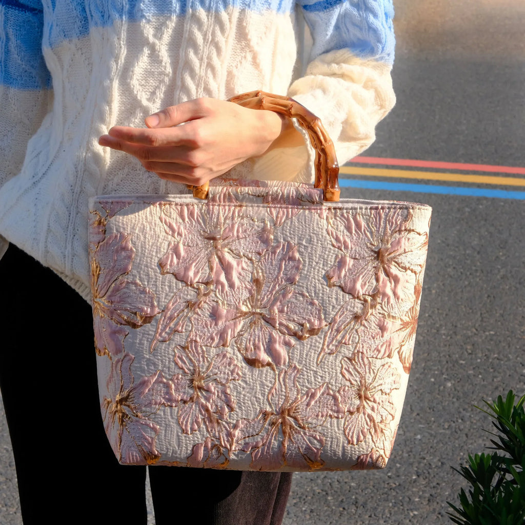 Light blue canvas shoulder bag with gold floral decoration and double shoulder straps