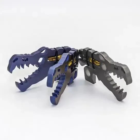 Grey TC4 titanium dinosaur head survival tool 78x42x5mm on a grey background