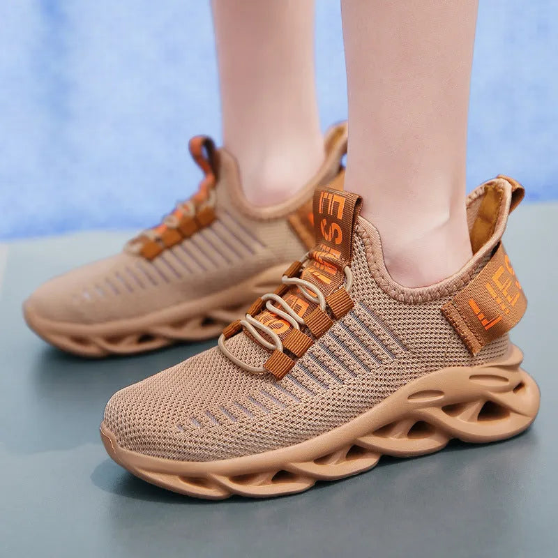 Children's black sneakers with Velcro strap, fabric upper, and patterned EVA sole.